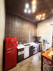 a kitchen with a red refrigerator and a sink at Noah's Ark Homestay in Huxi