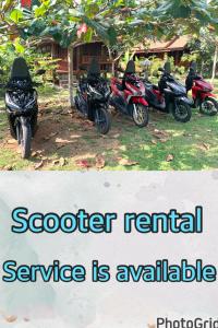 a group of motorcycles parked in front of a house at kohkoodfarmstay in Ban Ao Yai