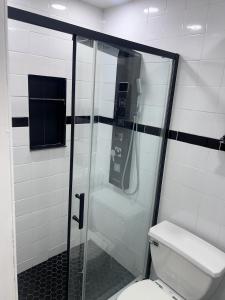 a bathroom with a shower with a toilet and a phone at Cozy & Relax LLC Airb&b in Brooklyn