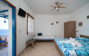 A bed or beds in a room at Iliovasilema VILLAGE