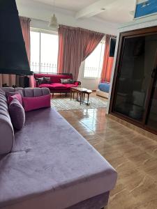 a living room with a couch and a tv at Riad Ras Lafaa in Safi