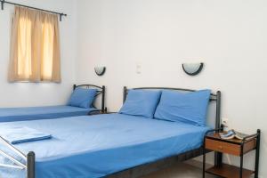 A bed or beds in a room at Iliovasilema VILLAGE