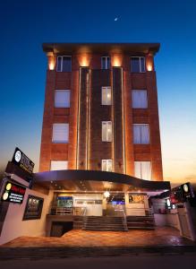 a tall building with a staircase in front of it at Hotel Dolphin International in Varanasi