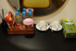 a table with a basket of food and drinks and plates at JOYCE HOUSE in Quy Nhon