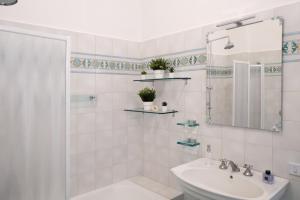 a white bathroom with a sink and a shower at SARA GUEST HOUSE TAORMINA in Taormina +33 photos