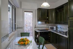 a kitchen with a plate of fruit on a table at SARA GUEST HOUSE TAORMINA in Taormina
