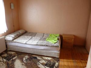 a small bedroom with a bed and a night stand at Комплекс Романтика in Kravenik