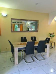 a dining room with a table and chairs at LE COROSSOL APPART in Mamoudzou