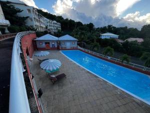 une vue aérienne d'une piscine avec des parasols dans l'établissement Location saisonnière vue Mer à TARTANE, à La Trinité