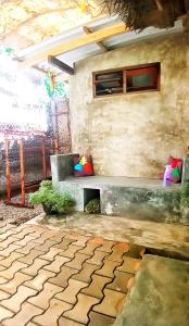 a stone wall with a bench in a room at Venora Hiriketiya in Dickwella