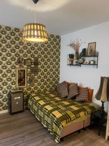 a bedroom with a bed and a pendant light at SOEPP the B&B in Alkmaar