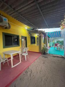 a room with a table and chairs and a tv at Krupasagar Homestay in Malvan