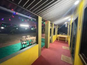 a room with a table and chairs and lights at Krupasagar Homestay in Malvan