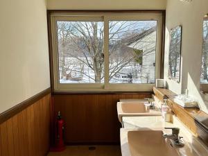 a bathroom with three sinks and a large window at Lakeside Hotels Kuore in Kitashiobara +98 photos