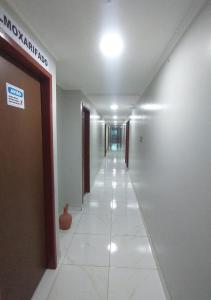 a hallway of a building with a long corridor at Pousada Chapada do Araripe in Araripina