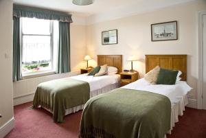 a hotel room with two beds and a window at Banbury Cross B&B in Banbury +93 photos