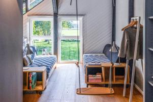 a room with two beds and a window at Ferienhaus Hyggeby - Architektenhaus mit Schlei Blick in Ulsnis