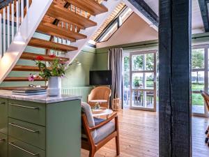 a home office with a staircase and a desk and chairs at Hyggeby - Architektenhaus mit Schleiblick, Sauna, etc in Ulsnis