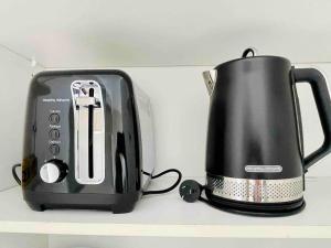 a black toaster sitting on top of a shelf at Opera & Harbour bridge view penthouse (3 rooms) in Sydney