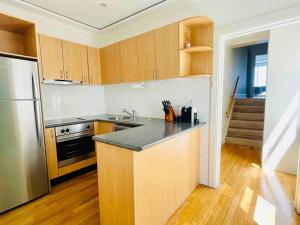 a kitchen with a refrigerator and a counter top at Opera & Harbour bridge view penthouse (3 rooms) in Sydney +23 photos