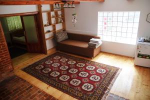 a living room with a couch and a rug at Casa Matteo in Arefu