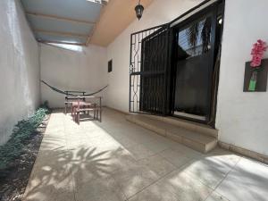 a patio with a table and a window at Villa Jade in Dakar