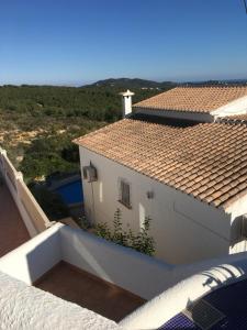a view from the balcony of a white house at Casa La Vida, stijlvolle Spaanse villa met uniek uitzicht! in Benitachell +40 photos