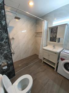a bathroom with a toilet and a sink at BEACH FRONT modern room + Free hi speed Wi-Fi in Ban Chak Phai