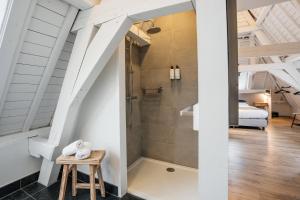 a bathroom with a shower in the middle of a room at Eye Hotel in Utrecht