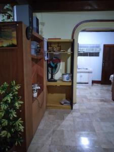 a living room with a kitchen and a room with a hallway at Camille's Cheapstay in Alaminos