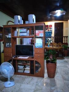 a room with a desk with a computer and a fan at Camille's Cheapstay in Alaminos
