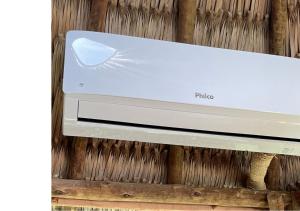 a white printer sitting on top of a wooden wall at Villa Sabiá - Eco Bungalows in Prea