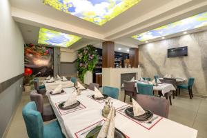 a restaurant with tables and chairs and a ceiling with skylights at Motel Milošević in Bijeljina