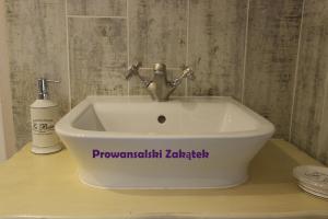 a white sink with a faucet on a counter at Domek Podróżniczy in Łódź +37 photos