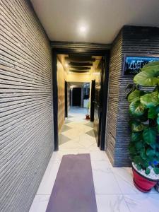 a hallway of a building with a plant at Hotel SeaView 2 in Karachi