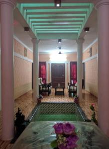 a living room with a table with flowers on it at Quality Inn Varkala in Varkala