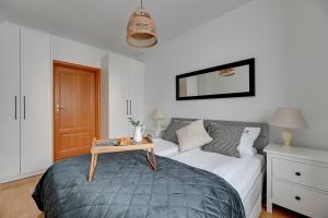 a bedroom with a bed with a table on it at Lion Apartments - Amalfi Quiet Family 3 Bedr Apartment in Sopot