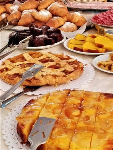 a table full of pies and pastries on plates at Hotel Patrizia - B&B e Appartamenti in Bellaria-Igea Marina +36 photos