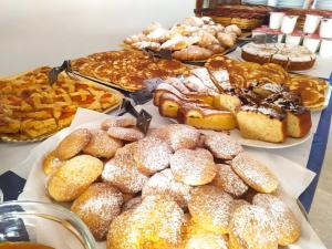 a table full of different types of pastries and pies at Hotel Patrizia - B&B e Appartamenti in Bellaria-Igea Marina