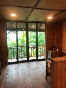 an empty room with a large glass door to a balcony at The Tropical Koh Mook in Ko Mook +205 photos
