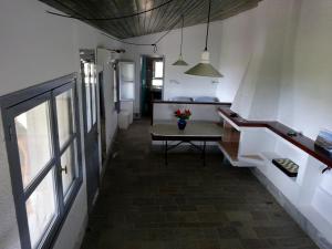 a hallway of a house with a table and a window at To Spitaki House in Perdika