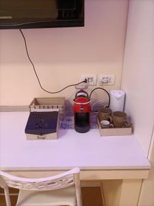 a table with a tea kettle and other items on it at La dimora del capitano in Quattordio