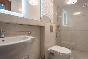a white bathroom with a sink and a toilet at Willa Anna Maria in Szklarska Poręba +53 photos