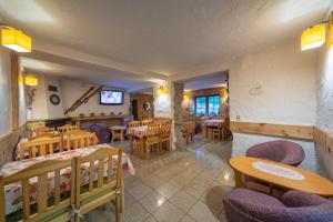 a restaurant with tables and chairs and a dining room at Willa Anna Maria in Szklarska Poręba