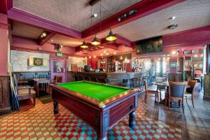a pool table in a room with a bar at The Victoria Hotel in Scarborough