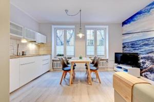 a kitchen and dining room with a table and chairs at UrbanNestGroup & Sw35/36 in Gdańsk