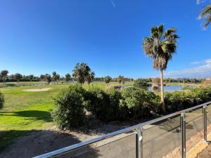 a view of a golf course with a palm tree at La casa de Mateo Playa Granada in Motril
