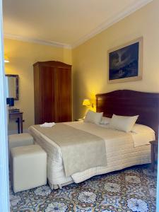 a bedroom with a large bed in a room at Hotel Akropolis - Museum Hotel in Taranto