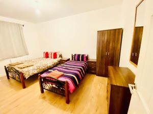 a bedroom with a bed in a room with wooden floors at One Bedroom Apartment In Ealing London in Ealing