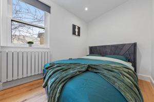 a bed in a white room with a window at Brand new Apartment near London Bridge LR1 in London